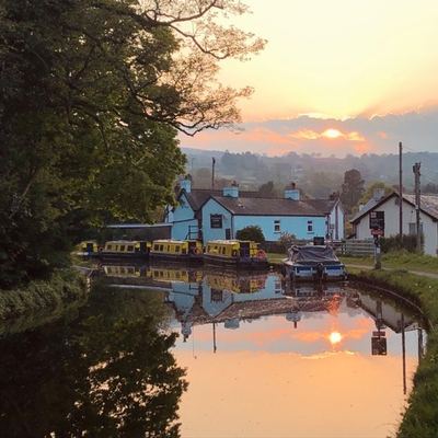 The canal at sunset with the pub reflected in the water